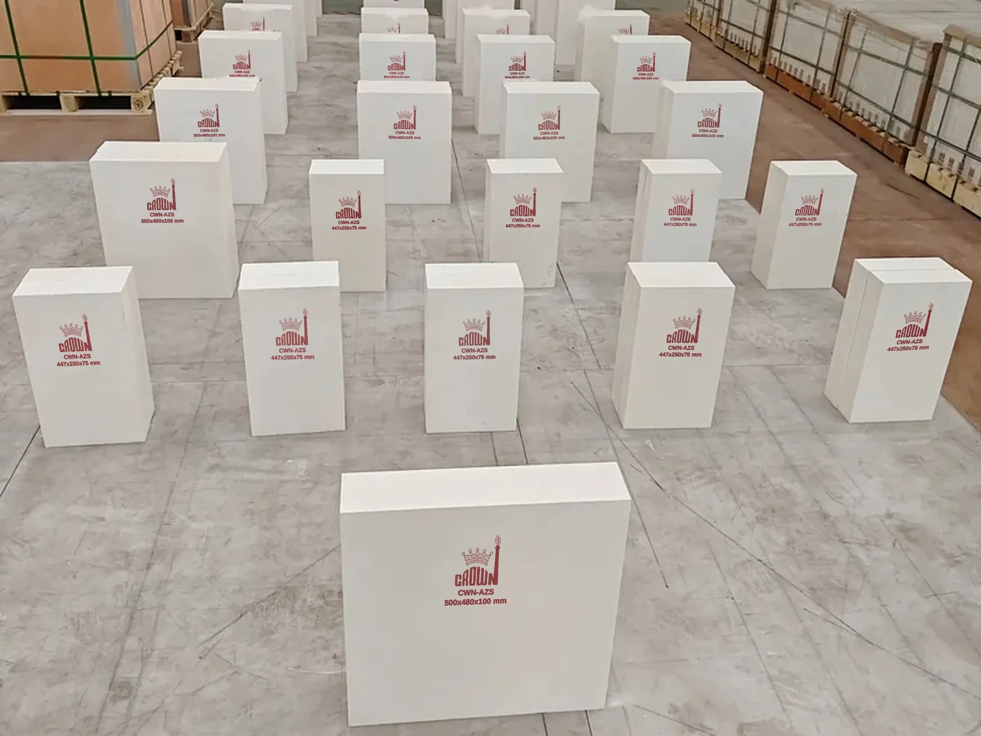 Rows of Crown CWN-AZS blocks on the works floor, each stencilled in red with the Crown mark, grade and its size