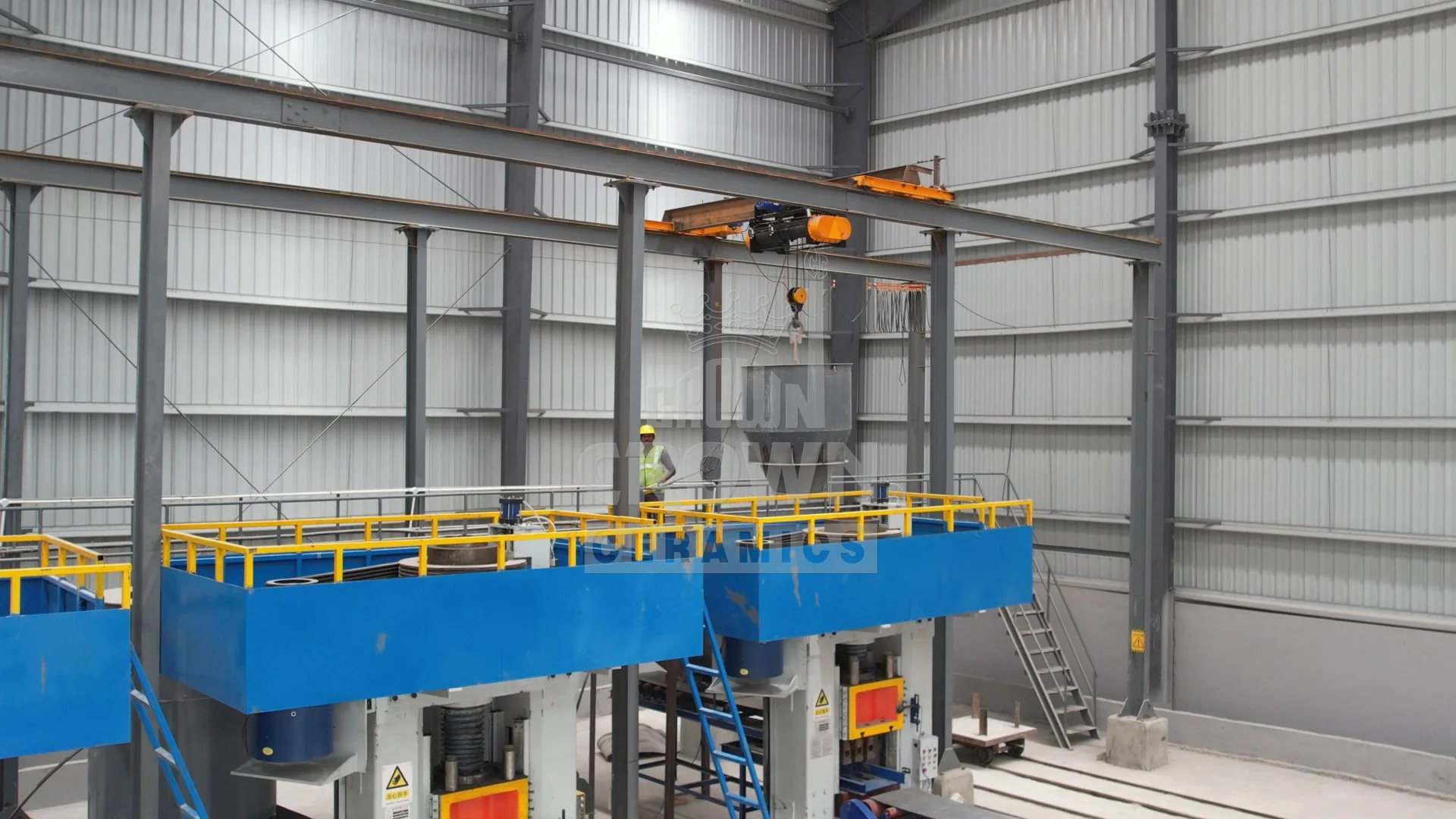 Material hopper craned onto the press deck above the electric screw presses